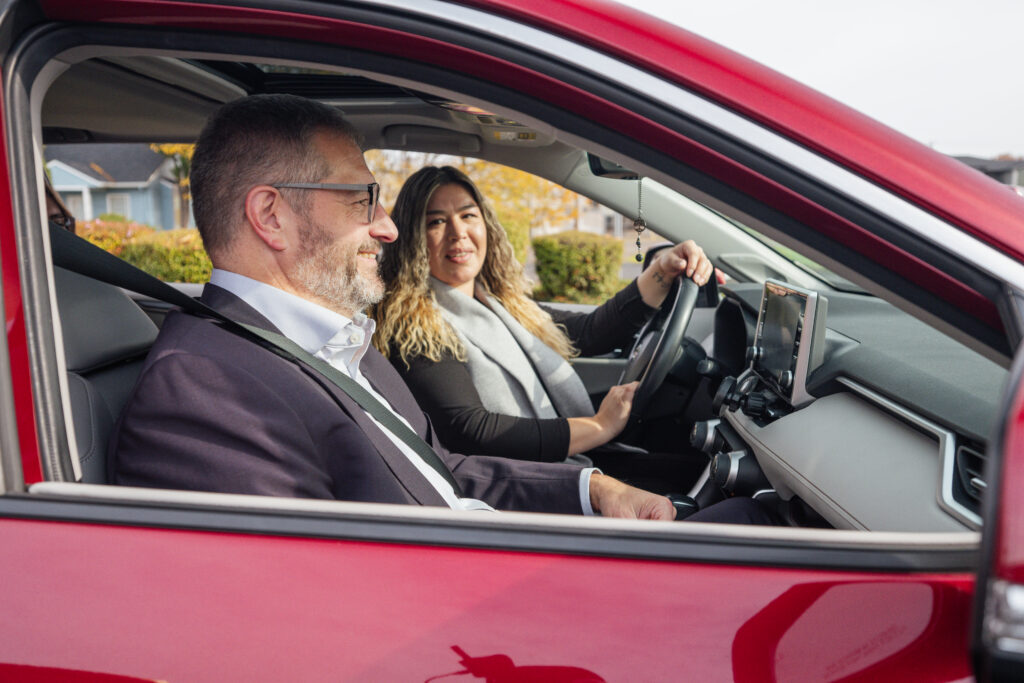 People chatting while carpooling in a red car