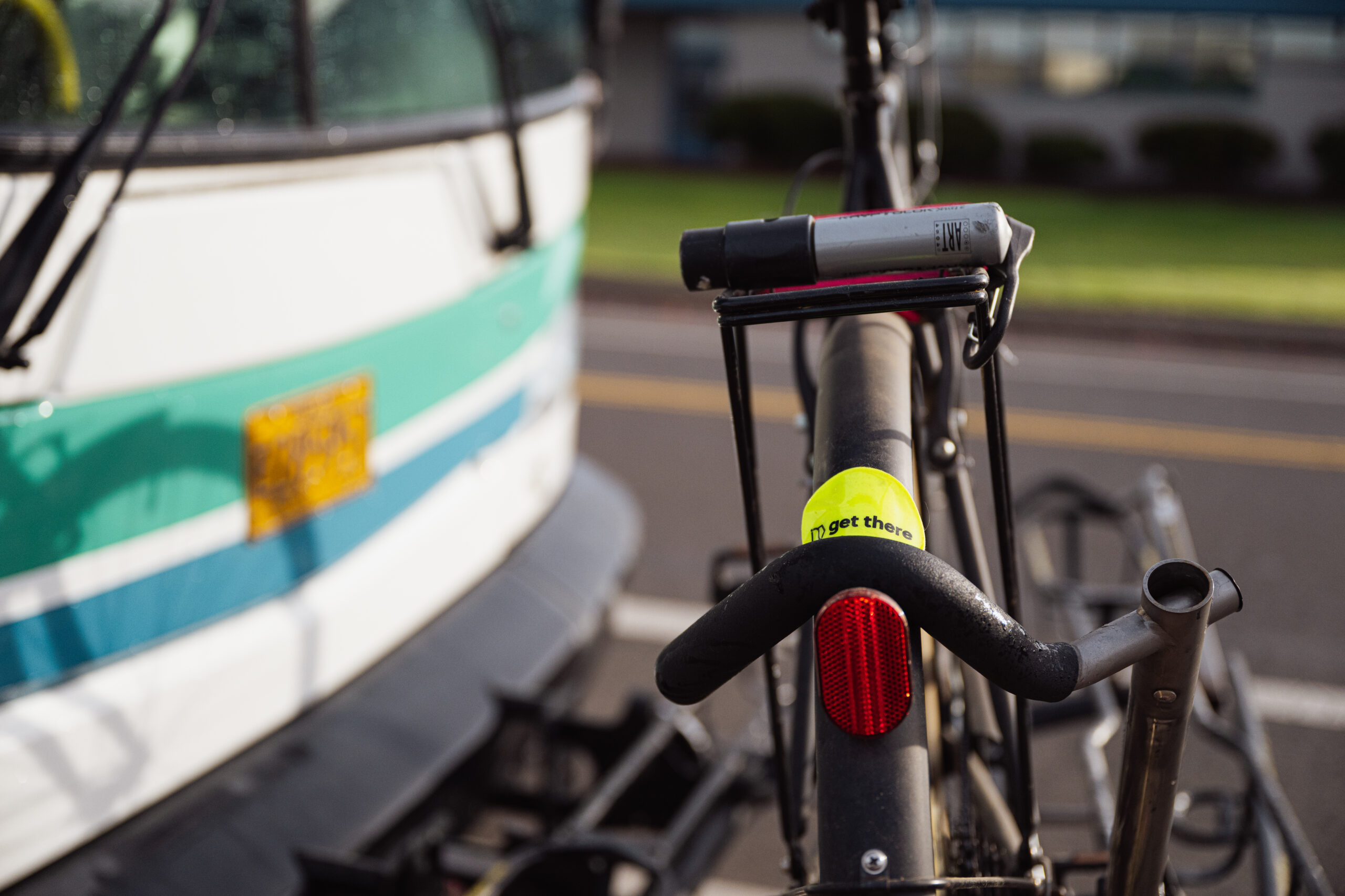 Closeup of a bike with a small Get There sticker mounted on the front of a bus.