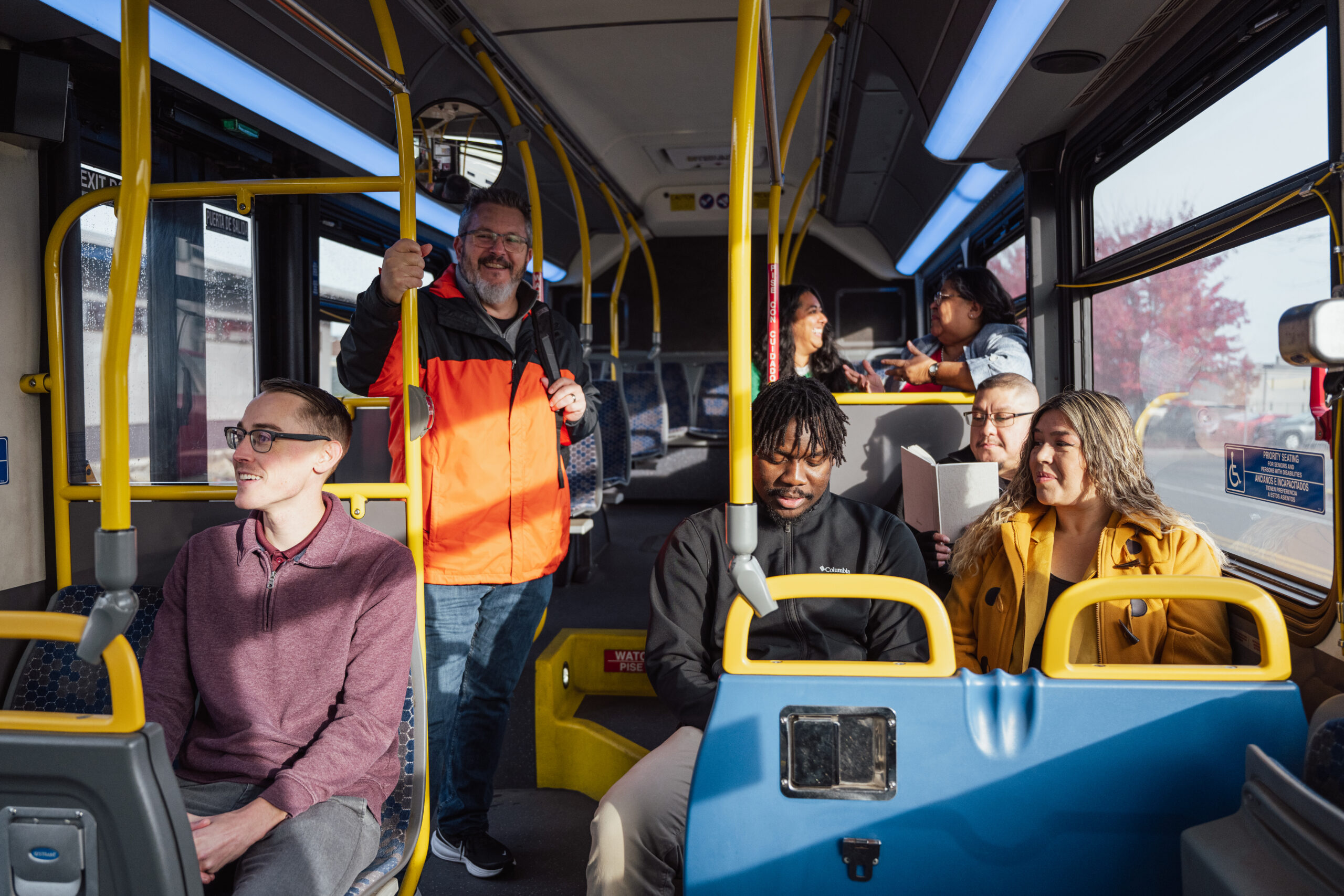 Many people riding inside a bus.
